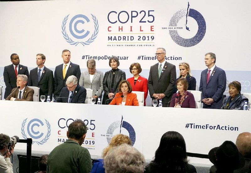 U.S. House Speaker Nancy Pelosi (center, front row) speaks Monday in Madrid as the U.N. Climate Change Conference opens in the Spanish capital. More photos are available at arkansasonline.com/125climate/ 