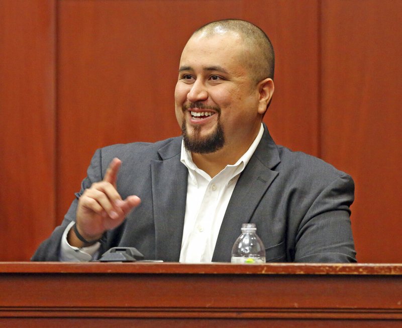 In this Sept. 13, 2016 file photo, George Zimmerman smiles as he testifies in a Seminole County courtroom in Orlando, Fla. Zimmerman, who was acquitted of the 2012 killing of an unarmed black teen Trayvon Martin, has filed a lawsuit, Wednesday, Dec. 4, 2019, against the teens' parents, family attorney and prosecutors who tried his case, claiming they coached a witness to give false testimony. (Red Huber/Orlando Sentinel via AP, Pool, File)