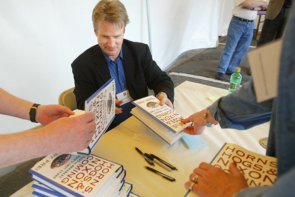 Terry Frei signs stacks of his book Horns, Hogs and Nixon Coming during the Arkansas Literary Festival Saturday afternoon in the Rivermarket.
