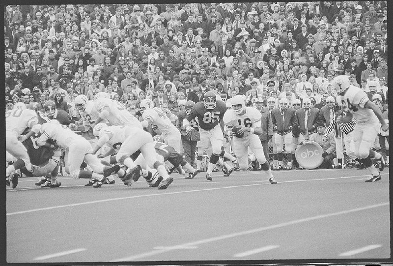 Texas quarterback James Street (16) runs down the line of scrimmage for the No. 1 Longhorns against No. 2 Arkansas at Fayetteville in a game held 50 years ago today. Texas scored 15 points in the fourth quarter and won 15-14. 