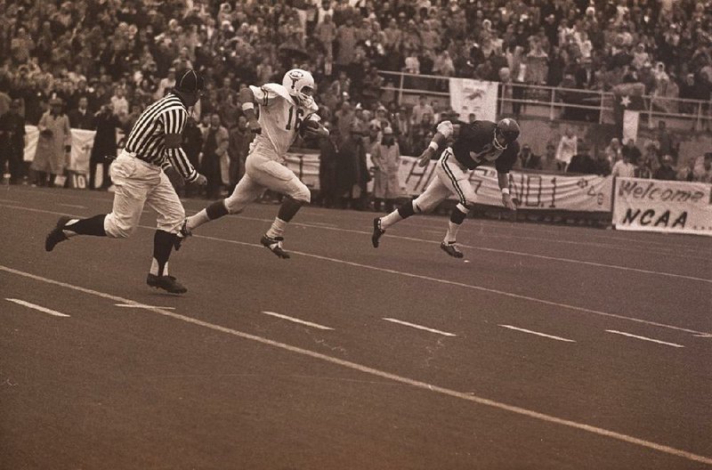 Quarterback James Street breaks away on a 42-yard touchdown run for Texas on the first play of the fourth quarter during the game against Arkansas at Razorback Stadium in Fayetteville on Dec. 6, 1969. Arkansas players, coaches and fans have insisted for 50 years that Arkansas linebacker Mike Boschetti was the victim of clipping penalty that wasn’t called on the play. - Arkansas Democrat Gazette file photo