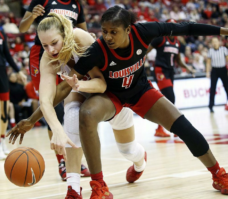 Ohio State forward Dorka Juhasz (left) battles Louisville’s Elizabeth Balogun for the ball in the  Buckeyes’ 67-60 victory over No. 2 Louisville on Thursday night. Juhasz led the Buckeyes with 15 points in the victory. 