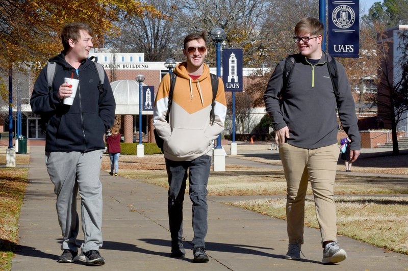 Students Mason Day (from left), Clay Leslie and Ethan Fielding walk Wednesday, December 4, 2019, across the campus of the University of Arkansas at Fort Smith.