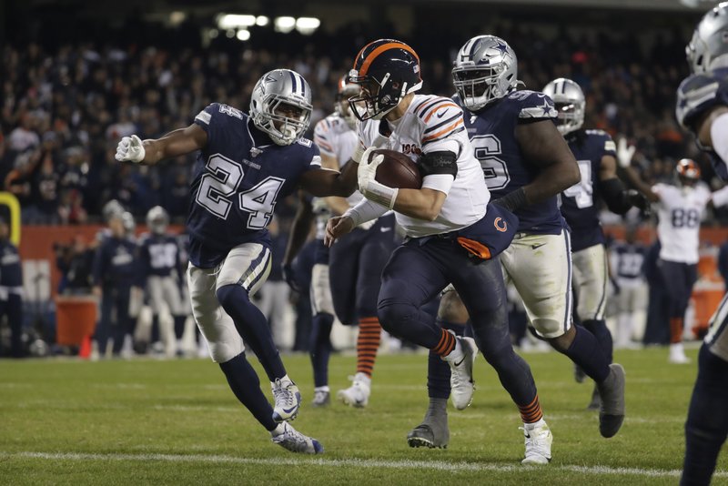 Chicago Bears quarterback Mitchell Trubisky (10) runs in for a touchdown against Dallas Cowboys' Chidobe Awuzie (24) during the second half of Thursday's game in Chicago. - Photo by Morry Gash of The Associated Press