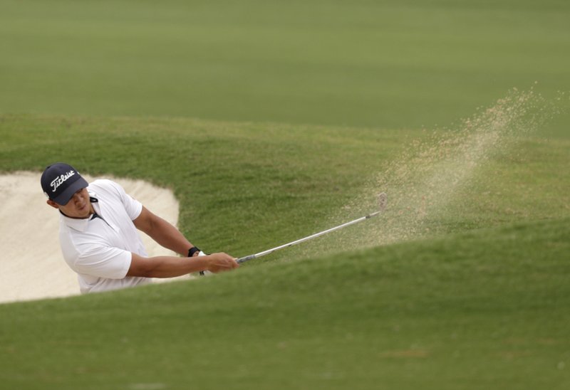 Denzel Ieremia of New Zealand plays out of a fairway bunker on the 18th hole Friday during the second round of the Australian Open in Sydney. - Photo by Rick Rycroft of The Associated Press