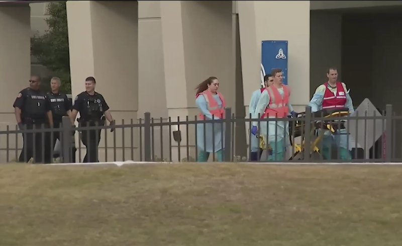 This photo taken from video provided by WEAR-TV shows emergency responders near the Naval Air Base Station in Pensacola, Fla., Friday, Dec. 6, 2019. The US Navy is confirming that an active shooter and one other person are dead after gunfire at the Naval Air Station in Pensacola. Area hospital representatives tell The Associated Press that at least 11 people were hospitalized. The base remains locked down amid a huge law enforcement response.  (WEAR-TV via AP)

