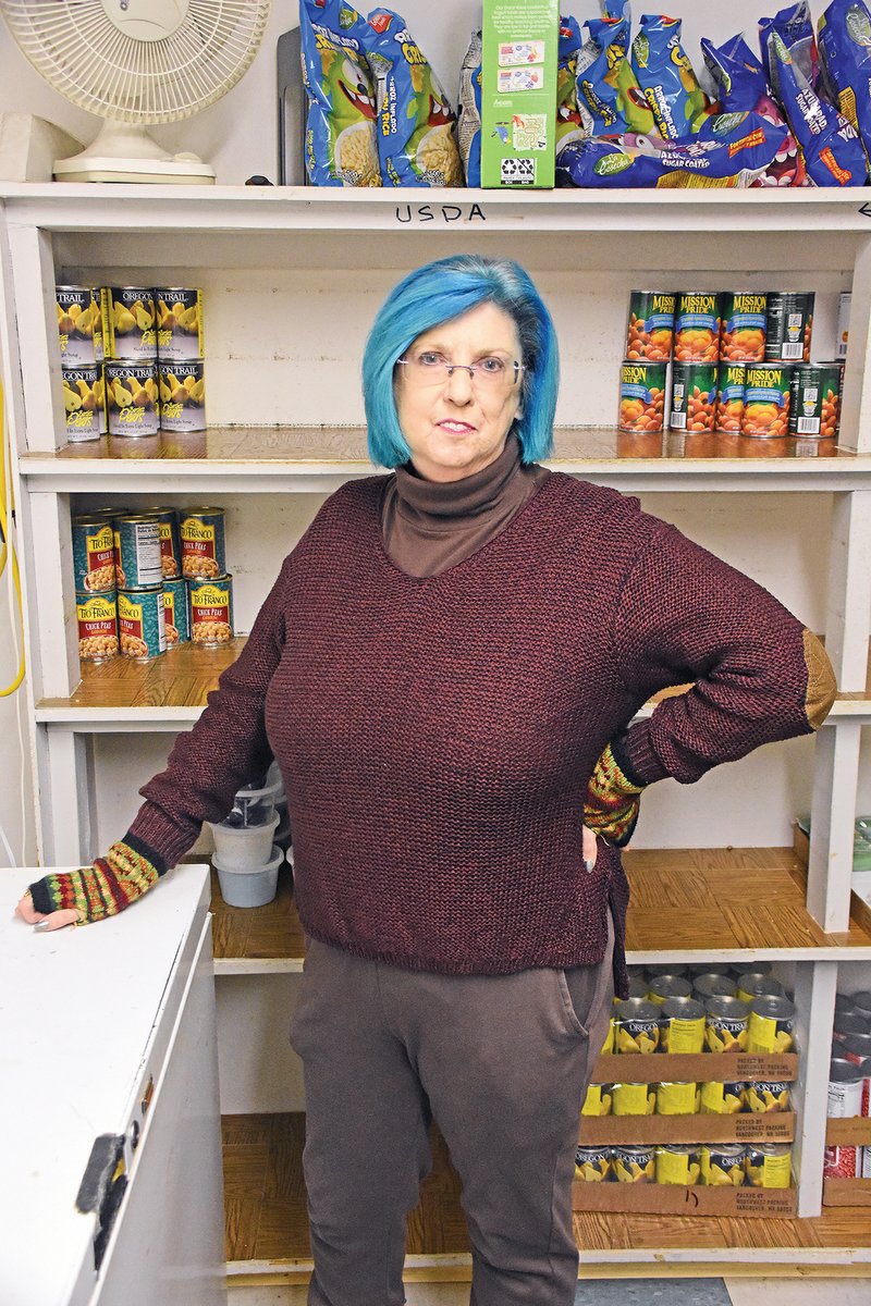 Pam Ray, food director for the Churches Joint Council on Human Needs, Churches and Charitable Organizations, or CJCOHN, stands in front of some of the food-pantry items available for those in need. Benton Mayor Tom Farmer and The Osage event venue will host a White Christmas Ballroom Dance on Thursday, with the proceeds benefiting CJCOHN.