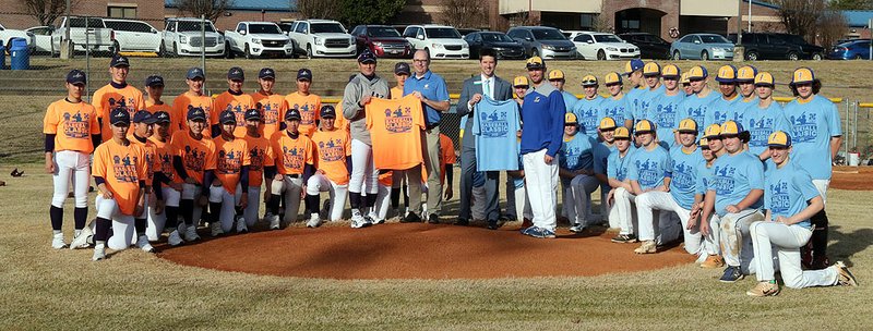 Hanamaki Higashi baseball team coach Hiroshi Sasaki, standing, middle left, Hill & Cox representative Robbie Cox, First Security Bank representative Scott Dews and Lakeside coach, Leighton Hardin, standing, middle right, with the Hot Springs area baseball team and the Higashi baseball team after a jersey ceremony at Lakeside Field on Wednesday. The teams will play in The First Ever Hot Springs Sister City Baseball Classic at 1 p.m. today. First Security Bank and Hill & Cox are sponsoring the event. - Photo by Richard Rasmussen of The Sentinel-Record