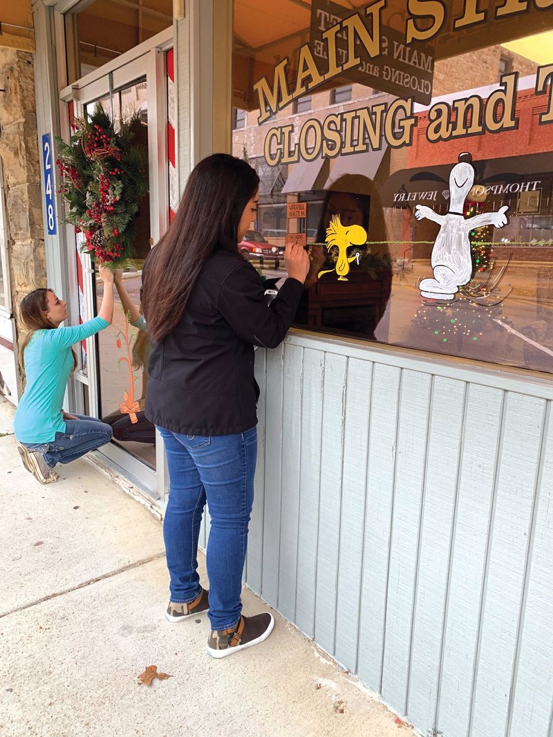 Shelby Shorrock, left, and Alma Medina paint scenes from A Charlie Brown Christmas at Main Street Closing and Title in time for the upcoming Old-Fashioned Christmas, set for Friday and Saturday in Batesville.