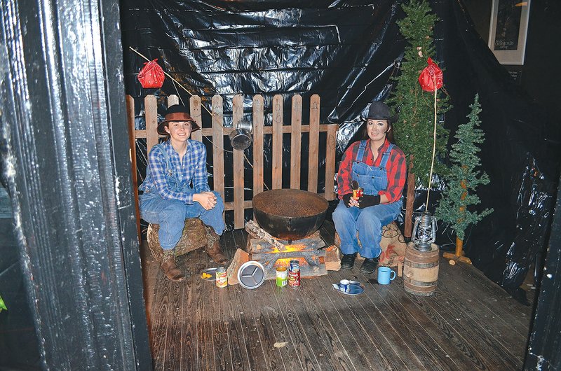 Kim Parnell, left, and Casey Lindsey portray hobos in a past Christmas Living Windows display sponsored by the Calico Rock Museum and Visitors Center. This year’s displays will begin at 5:30 p.m. Saturday and will close at 6:30, prior to the city’s Lighted Christmas Parade, set for 6:45.