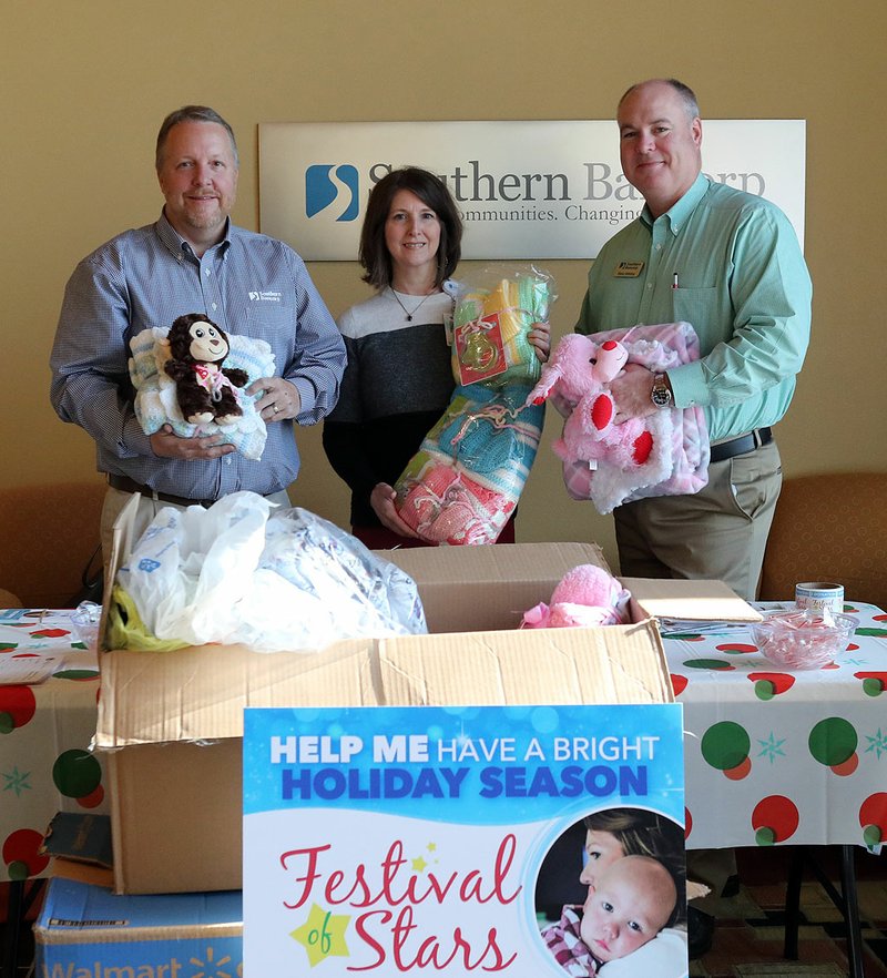 Southern Bancorp Market President Ron Magby, left, Arkansas Children's Hospital Foundation Senior Development Officer Becky McCauley and Southern Bancorp Division President Blake Whitley display some of the items collected Friday during the annual Festival of Stars Toy and Donation Drive. - Photo by Richard Rasmussen of The Sentinel-Record