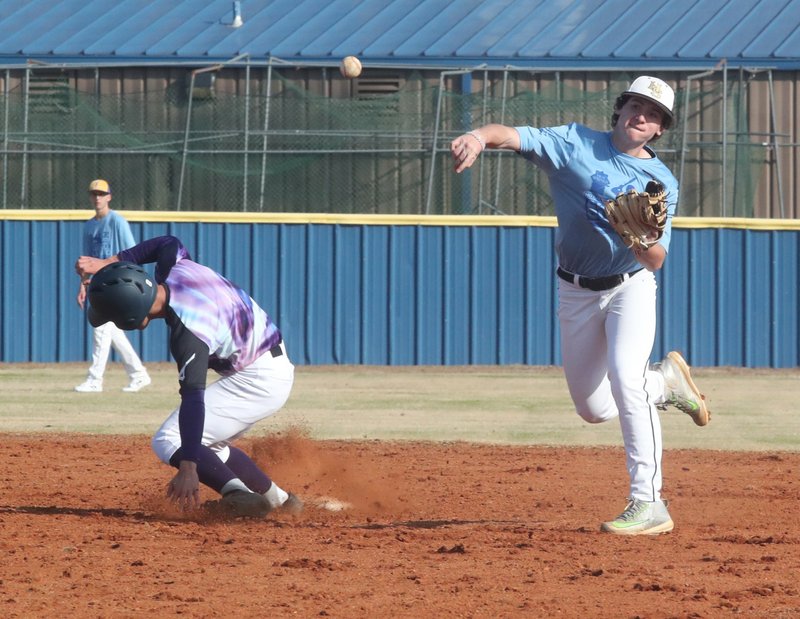 Hot Springs baseball player Isaac Shelor throws the ball to first during action against the Hanamaki Higashi team during a practice game at Lakeside Friday. Players from Lakeside and Hot Springs will join forces to play against the Japanese team today at 1 p.m. at Lakeside. - Photo by Richard Rasmussen of The Sentinel-Record