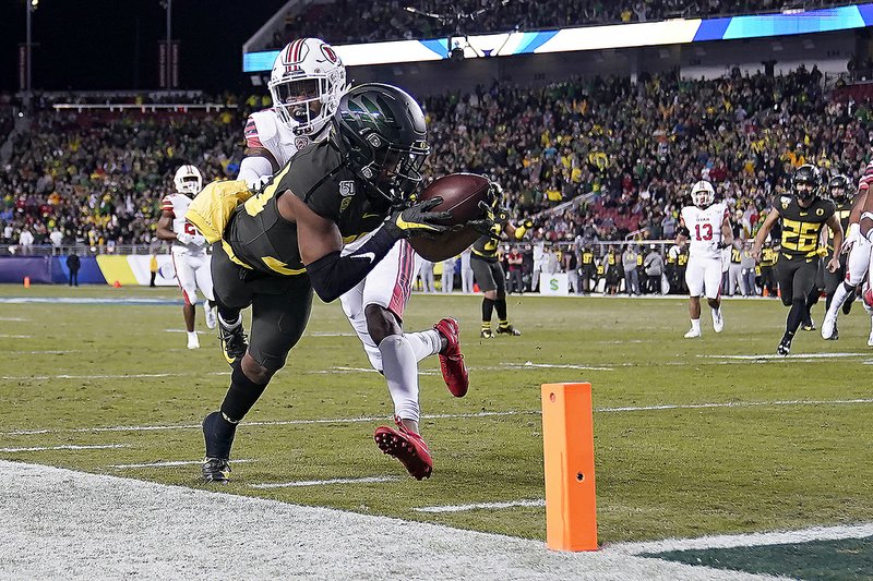 Oregon wide receiver Jaylor Redd (front) is pushed out of bounds by Utah defensive back Josh Nurse short of the goal line Friday during the No. 13 Ducks’ 37-15 victory over the No. 5 Utes in the Pac-12 Championship Game at Levi’s Stadium in Santa Clara, Calif.