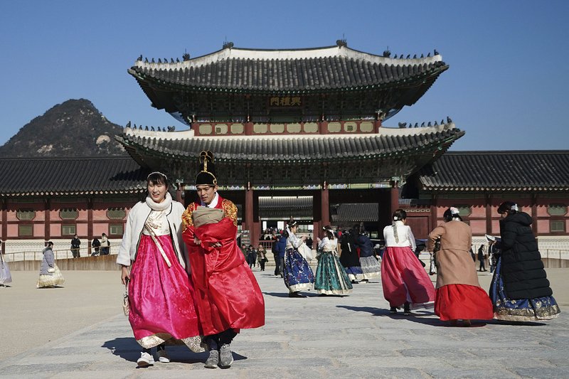 Visitors dressed in traditional attire on a cold Friday tour of Gyeongbok Palace in Seoul, a royal dwelling built in the 14th century and one of South Korea’s best-known landmarks. 