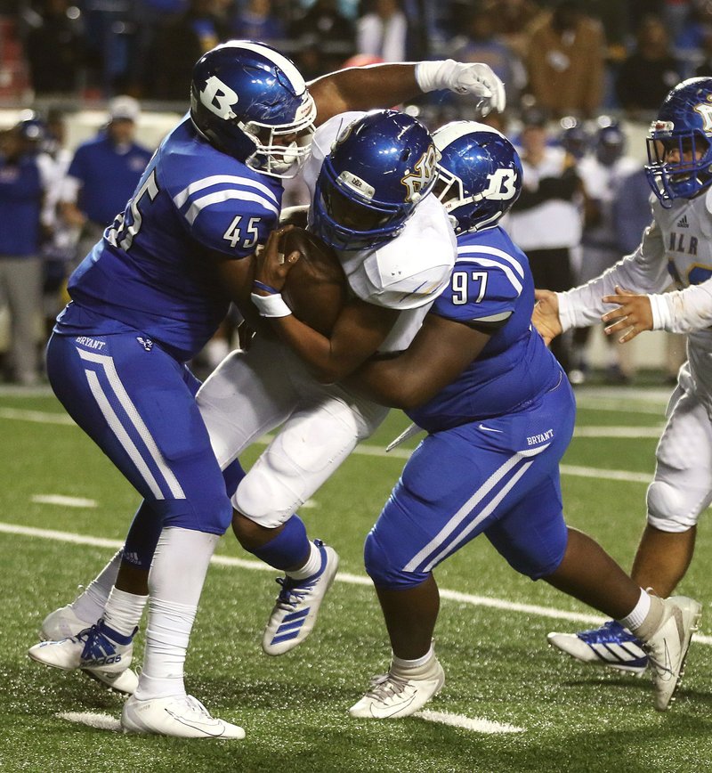 Bryant linebacker Austin Bailey (left) and defensive lineman Andy Scott (right) combine to sack North Little Rock quarterback Kareame Cotton during the second quarter.