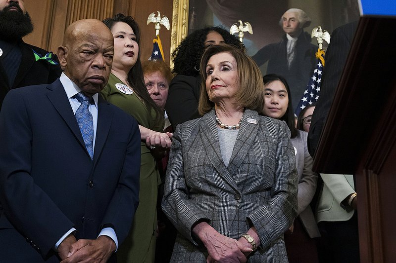 House Speaker Nancy Pelosi stands with U.S. Rep. John Lewis, D-Ga., at an event Friday in Washington before the House approved the Voting Rights Advancement Act to eliminate potential voter-suppression laws. Pelosi has directed key committees to begin writing articles of impeachment on President Donald Trump. More photos at at arkansasonline.com/127impeachment/ 