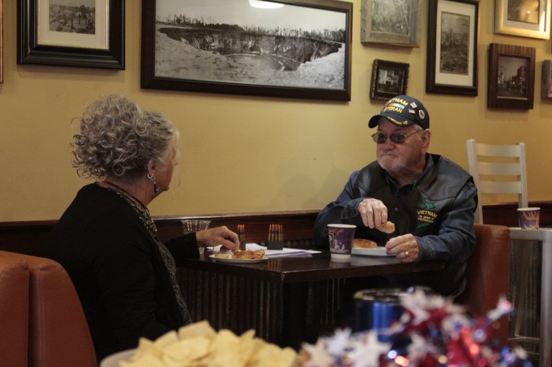 Joyce and David Nesbit eat breakfast at an event commemorating the 78th anniversary of a Japanese surprise attack on the Pearl Harbor naval base. David Nesbit is a Vietnam War veteran and he and Joyce both contribute to veterans organizations to this day.