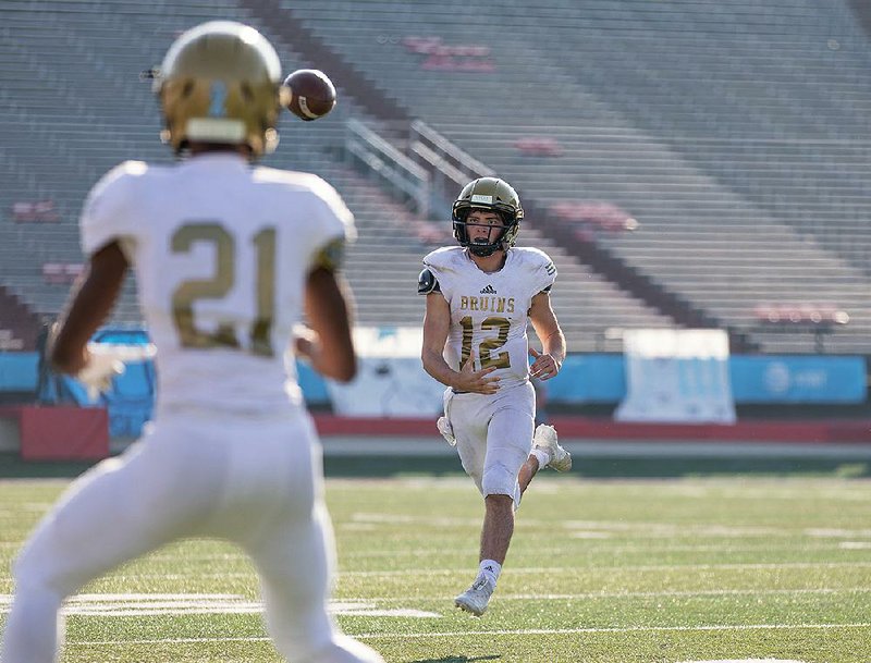 Pulaski Academy quarterback Braden Bratcher fires a pass to Jayden Kelley during Saturday’s Class 5A championship game at War Memorial Stadium in Little Rock. Bratcher passed for 439 yards and 5 touchdowns, and rushed for 125 yards and another score for the Bruins. More photos are available at arkansasonline.com/128palrchristian.