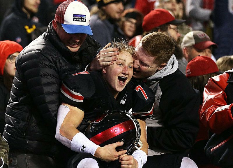 Senior wide receiver Tanner Leonard celebrates with Searcy fans after the Lions’ victory over Benton in Saturday’s Class 6A championship game at War Memorial Stadium in Little Rock. More photos are available at arkansasonline.com/128bentonsearcy.
