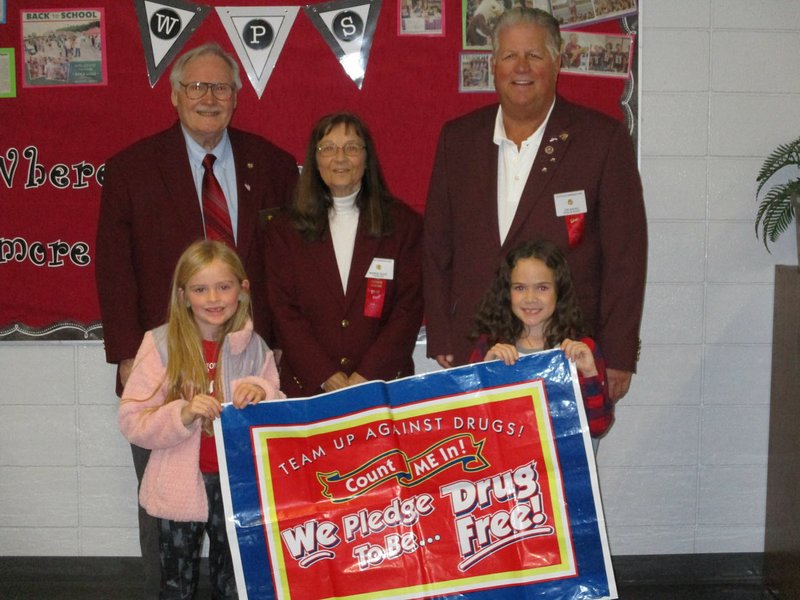 Courtesy Photo Three members of the Fayetteville-Springdale Elks Lodge marched with 1,000 students and 130 school staff in the conclusion of Red Ribbon Week in Huntsville. They chanted "no to drugs" during the one-hour march. Pictured (left to right) are students Paige Waters and Jacqueline Mitchell and at the rear are Ron Materna, the lodge drug awareness chairman, Marge Guist, lodge chaplain and Joe Hayes, the lodge president. The lodge also delivered 43,000 Red Ribbon stickers, 5,000 drug awareness pamphlets, 500 comic books and 3,500 coloring books to 70 schools in six school districts.