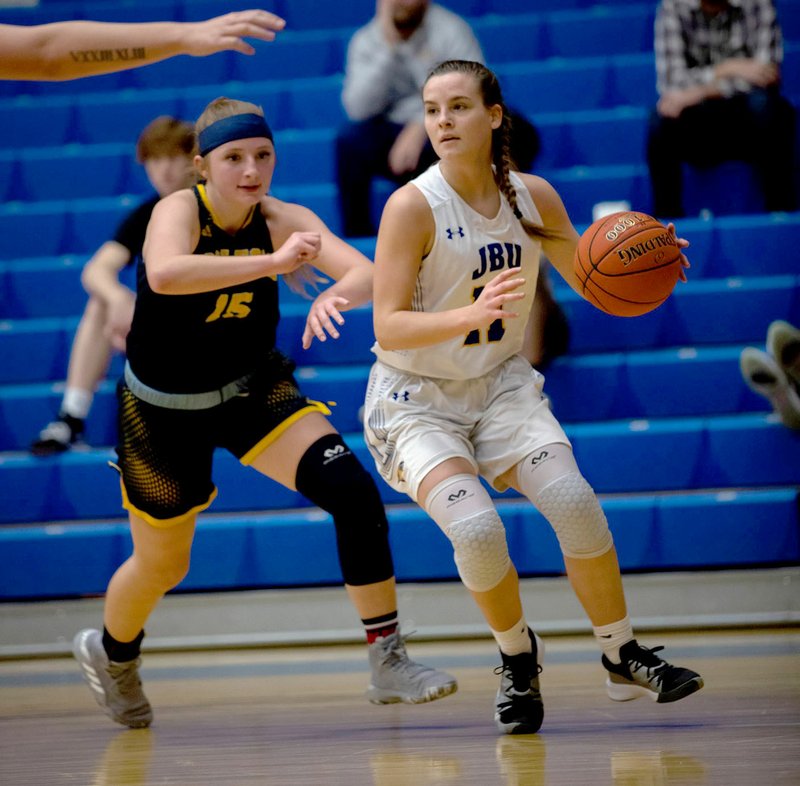 Photo courtesy of JBU Sports Information John Brown sophomore Maddie Altman (right) looks to make a play during Tuesday's game against Ecclesia at Bill George Arena.