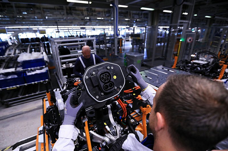 A worker mans the assembly line at a Volkswagen electric-vehicle factory in Zwickau, Germany. 