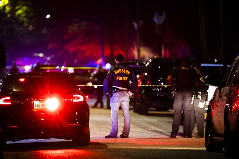 Houston Police Department officers stand by the scene of a shooting in Houston on Saturday, Dec. 7, 2019. A Houston police officer was shot Saturday evening and a suspect was being sought, authorities said. 

