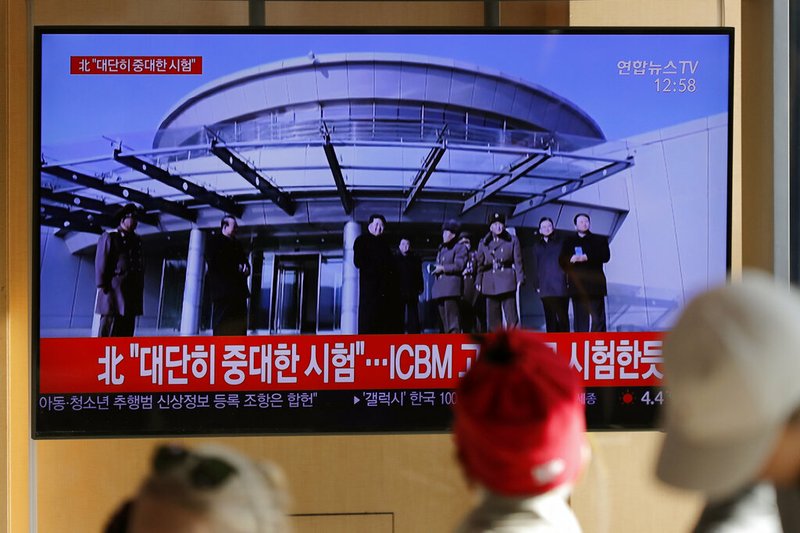 People watch a TV news program reporting North Korea's announcement with a file footage of North Korean leader Kim Jong Un, at the Seoul Railway Station in Seoul, South Korea, Sunday, Dec. 8, 2019. 