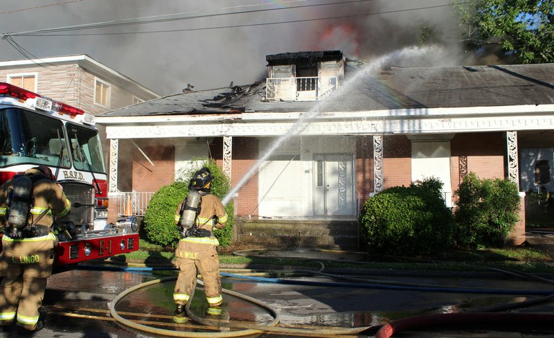 Hot Springs Fire Department firefighters battle a structure fire at 134 Gulpha St. on May 6, 2017. - File photo by The Sentinel-Record