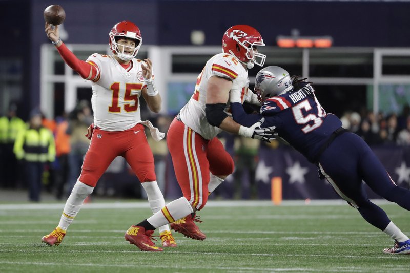 Kansas City Chiefs quarterback Patrick Mahomes. left, passes under pressure from New England Patriots linebacker Dont'a Hightower, right, in the first half of an NFL football game, Sunday, Dec. 8, 2019, in Foxborough, Mass. (AP Photo/Steven Senne)