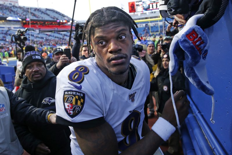 Baltimore Ravens quarterback Lamar Jackson (8) heads to the locker room after stopping to sign autographs for fans following a 24-17 win over the Buffalo Bills in an NFL football game in Orchard Park, N.Y., Sunday, Dec. 8, 2019. (AP Photo/John Munson)