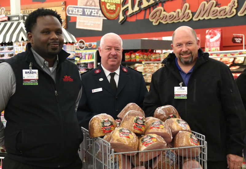 North West Brookshire's director Brady Stripling, Salvation Army Captain Jason Perdieu and South West Brookshire's director John Tomanio pose for a photo at South West Brookshire's Dec. 10, 2019. Brookshire's donated 45 Hormel Cure 81 hams to the Salvation Army for the holidays.
