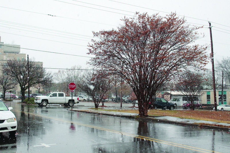 Snowflakes: Snow falls near downtown El Dorado yesterday afternoon. At some points during the on-and-off snowfall, very large snowflakes fell quickly and heavily. 