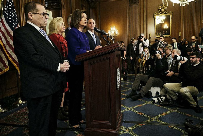 House Speaker Nancy Pelosi, surrounded by the leaders of six key House committees Tuesday on Capitol Hill, announces the articles of impeachment against President Donald Trump. More photos are available at arkansasonline.com/1211impeachment/.
(The New York Times/T.J. Kirkpatrick)