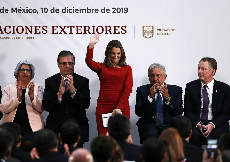 Mexican Foreign Minister Marcelo Ebrard (from left), Canadian Deputy Prime Minister Chrystia Freeland, President Andres Manuel Lopez Obrador of Mexico and U.S. Trade Representative Robert Lighthizer gather Tuesday in Mexico City to sign the new North American trade deal. More photos are available at arkansasonline.com/1211usmca/.
(AP/Marco Ugarte)