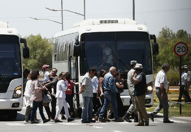 Relatives of passengers of a missing military plane arrive by bus Tuesday at the Cerrillos airbase in Santiago, Chile.
(AP/Luis Hildago)