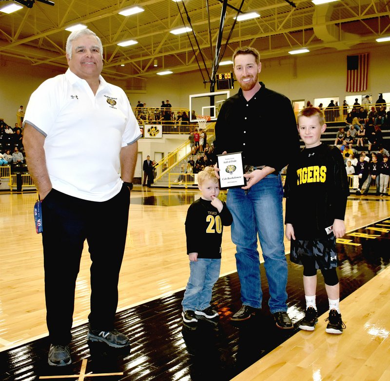 MARK HUMPHREY ENTERPRISE-LEADER/Prairie Grove legend Colt Bartholomew celebrates his induction into the Prairie Grove Hall of Pride with his sons, Brody, 9, (right) and Witten, 3; along with Prairie Grove athletic director Dave Torres (left). Colt Bartholomew graduated from PGHS in 2002 earning All-State and All-Conference honors in football and All-Conference recognition in basketball as well as track and field. More details on his career next week.