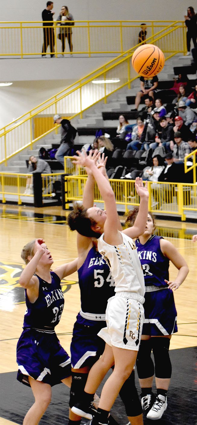 MARK HUMPHREY ENTERPRISE-LEADER/Prairie Grove sophomore Trinity Dobbs draws a crowd as Elkins defenders converge on her. Dobbs scored 22 points to lead the Lady Tigers past Elkins, 38-32, Friday.