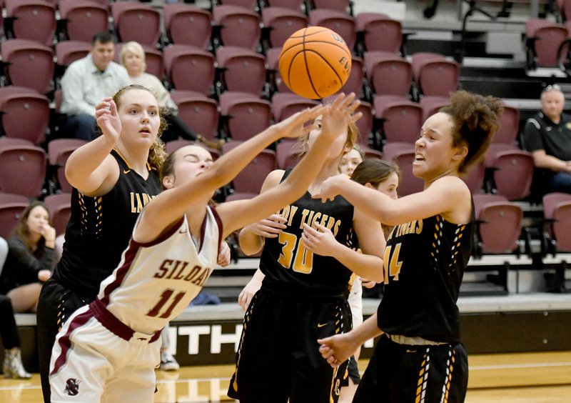 Bud Sullins/Special to Siloam Sunday A trio of Prairie Grove defenders, Olivia Kestner, Abby Preston and Trinity Dobbs, defend against Siloam Springs junior Quincy Efurd during a Tuesday, Nov. 26 game at Panther Activity Center. Prairie Grove defeated Siloam Springs 59-55.