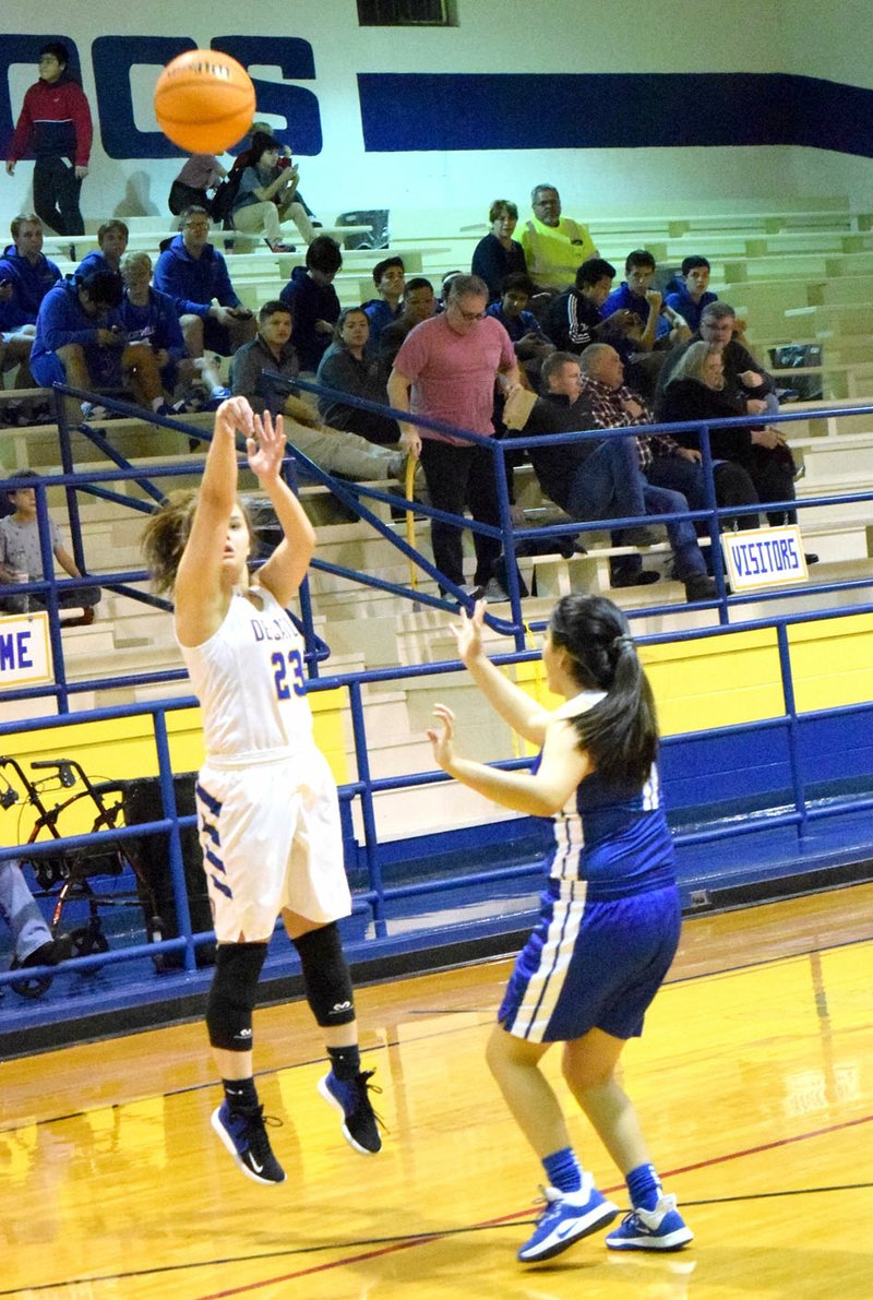 Westside Eagle Observer/MIKE ECKELS Abby Tilley (Decatur 23) attempts a three-point field goal during the first quarter of the Decatur-Ozark Catholic Academy basketball contest at Peterson Gym Dec. 3. Tilley missed this attempt but her earlier three-pointer hit its mark for a Decatur lead.