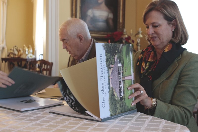 Signing: Tom Whitehead (left) and Diny Nolan Landen sign copies of their book, “Cherokee Plantation on the Cane River,” yesterday afternoon at the Newton House Museum.