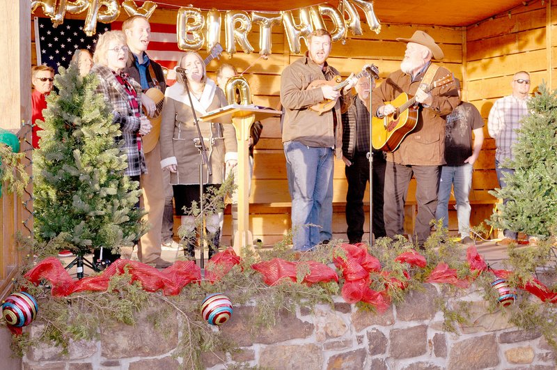 RACHEL DICKERSON/MCDONALD COUNTY PRESS The Walker Family of Roundup Ministries sings "Go Tell it on the Mountain" during the Pineville 100th birthday celebration on Saturday, Dec. 7.