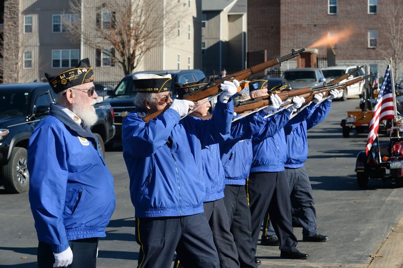 NWA Democrat-Gazette/ANDY SHUPE Members of the Rogers American Legion post Honor Guard give a three-volley rifle salute Wednesday during a funeral service for four U.S. military veterans who were classified as 'unclaimed' at Fayetteville National Cemetery. Officials at the cemetery worked with the Washington County Coroner's Office, Bo's Blessings and other local veterans service organizations to honor and bury the former service members.