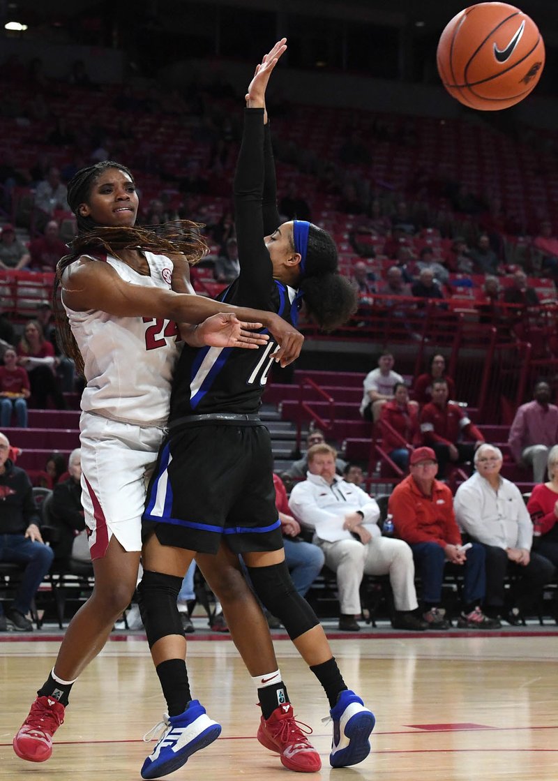 NWA Democrat-Gazette/J.T. WAMPLER Arkansas' Taylah Thomas makes a pass while Tulsa's Alexis Gaulden applies pressure Wednesday Dec. 11, 2019 at Bud Walton Arena in Fayetteville.