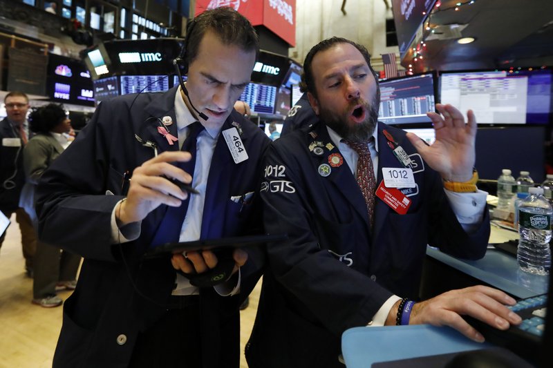 FILE - In this Dec. 5, 2019, file photo, trader Gregory Rowe, left, and specialist Michael Pistillo work on the floor of the New York Stock Exchange. The U.S. stock market opens at 9:30 a.m. EST on Thursday, Dec. 12. (AP Photo/Richard Drew, File)

