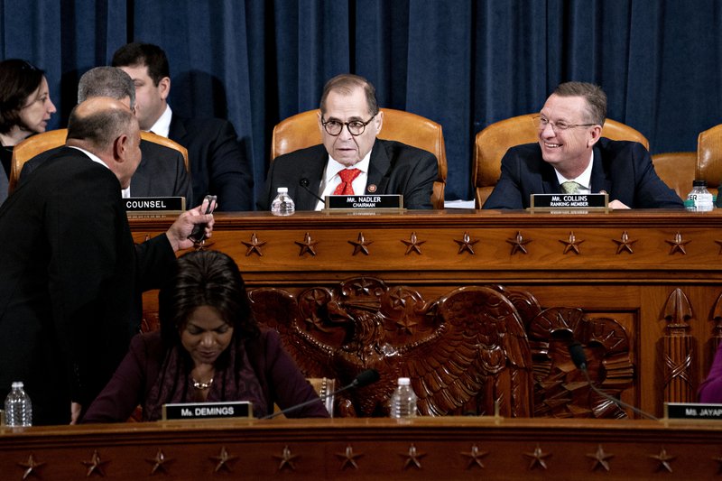 House Judiciary Committee ranking member Rep. Doug Collins, R-Ga., and House Judiciary Committee Chairman Rep. Jerrold Nadler, D-N.Y., talk with Rep. Luis Correa, D-Calif., left, during a House Judiciary Committee markup of the articles of impeachment against President Donald Trump, on Capitol Hill in Washington, Thursday, Dec. 12, 2019. 