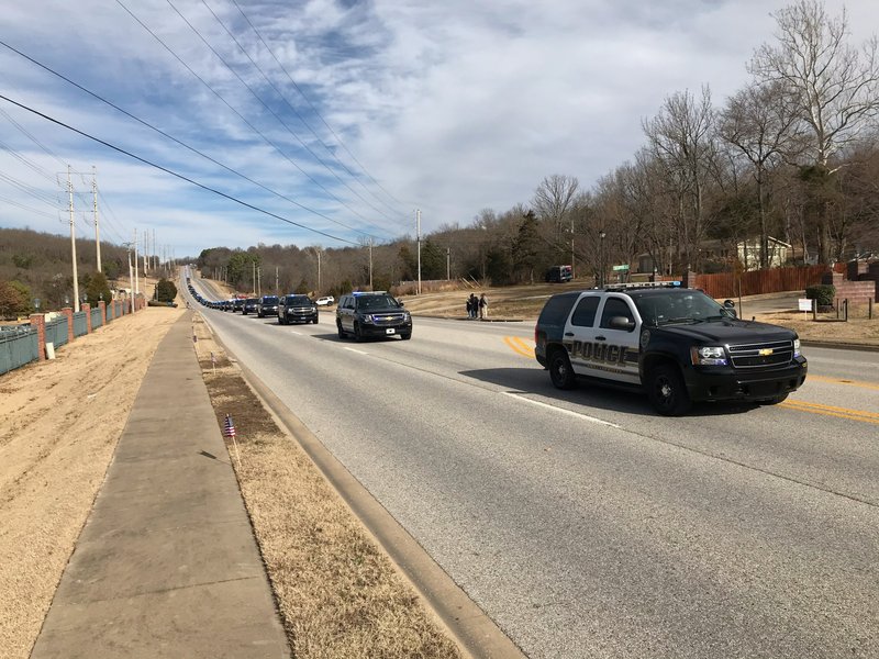 Officers escorted the body of Stephen Carr across Fayetteville in a procession on the way to a funeral at Bud Walton Arena on Thursday.