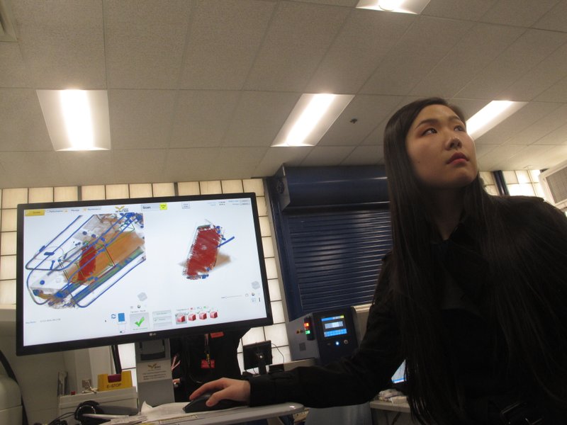 In this Dec. 12, 2019 photo, Bijia Chen, an engineer with a technology company that won a federal contest to find new or better ways to scan incoming mail for illegal opioid shipments, demonstrates how the computer analysis works at a demonstration in Egg Harbor Township, N.J. (AP Photo/Wayne Parry)