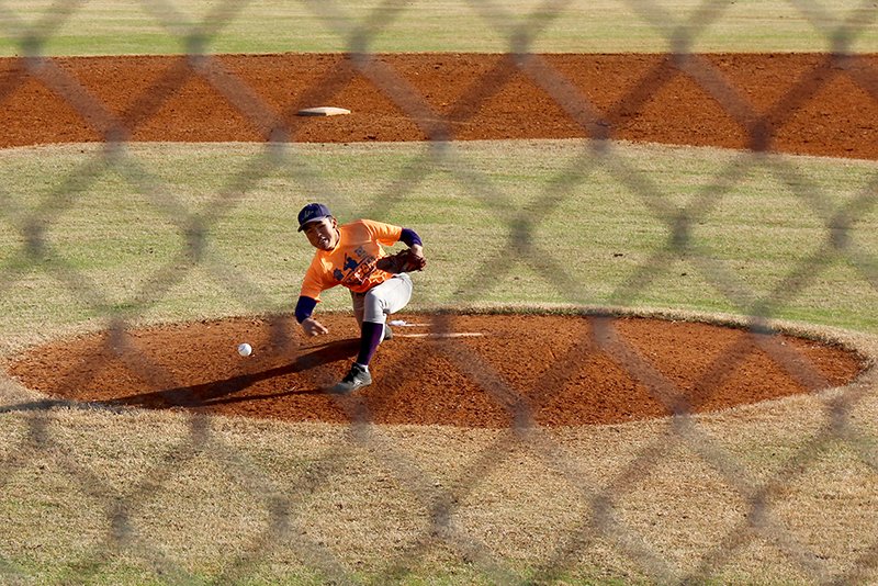 Higashi High School pitcher Yuito Funakoshi delivers a pitch to a Lakeside player during the Sister City Classic. Funakoshi is using the submarine-style of pitching. - Photo by James Leigh of The Sentinel-Record