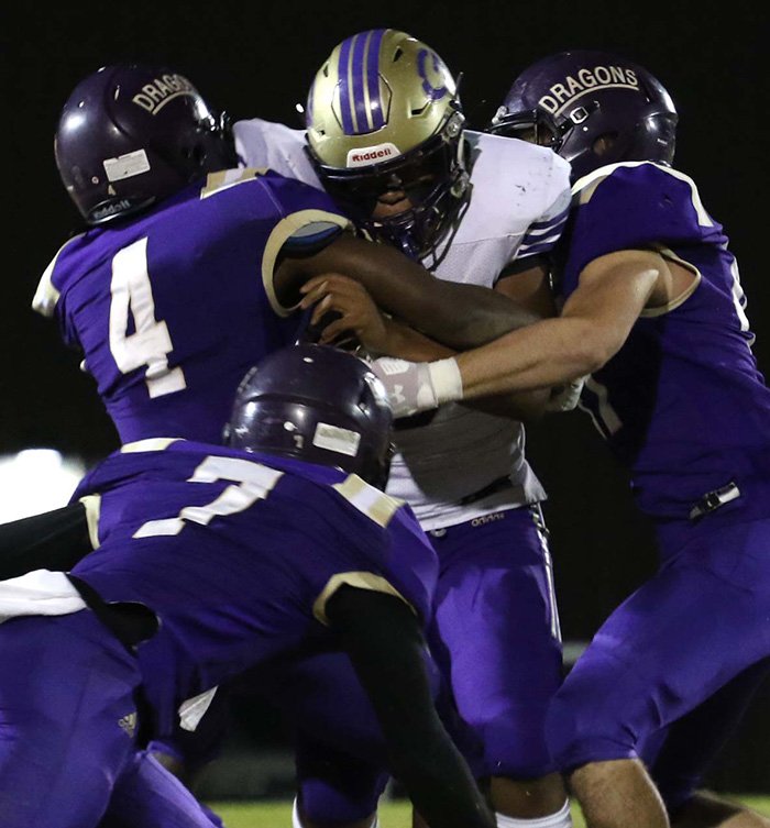 Siandhara Bonnet/News-Times A trio of Junction City defenders try to bring down Gurdon's Royrick Anderson during the first quarter of the 2A state semifinals on Dec. 6.